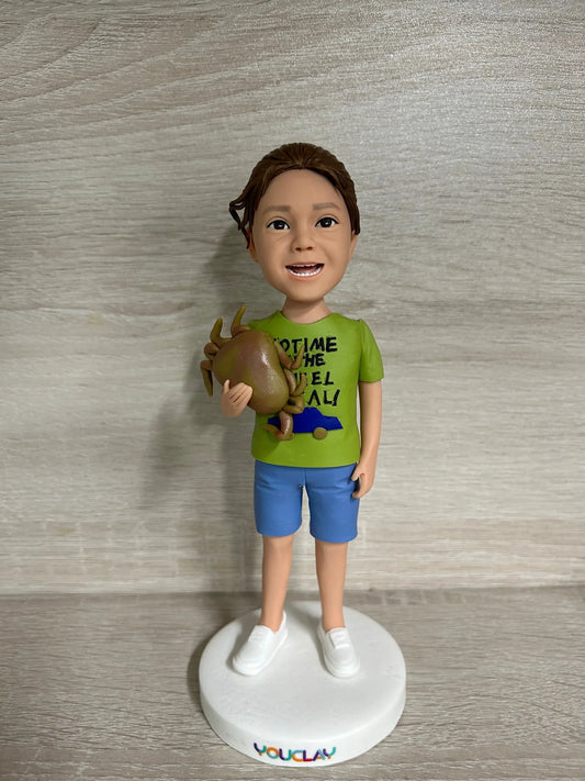 Personalized child bobblehead hand-sculpted in polymer clay from a photo by YOUCLAY